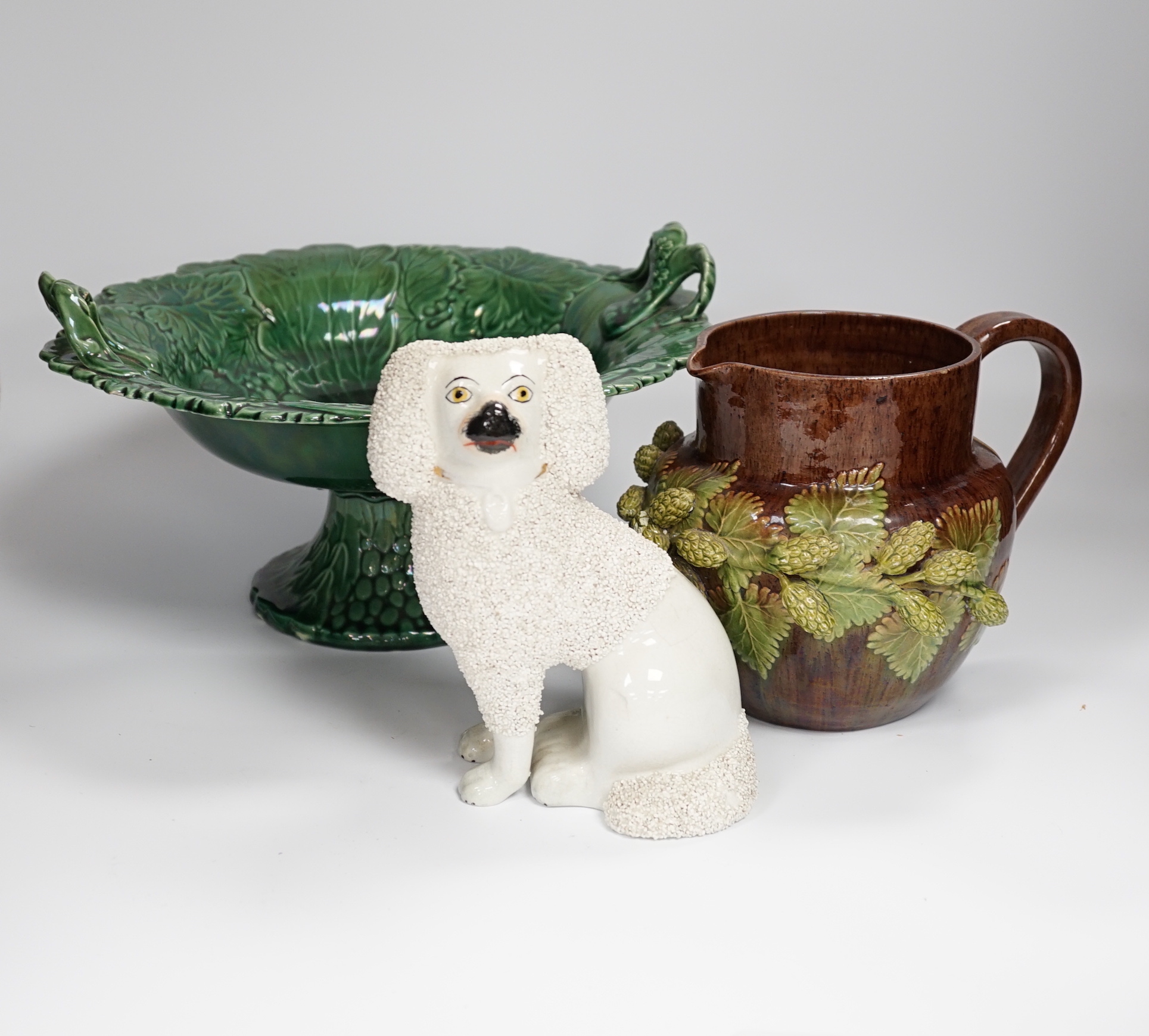 Seven items including a pair of toleware vases and covers, a Rye pottery jug, three Staffordshire dogs and a green leaf pedestal dish, Rye jug 16cm high